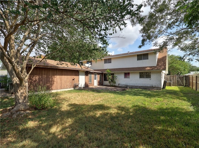 rear view of property with a yard