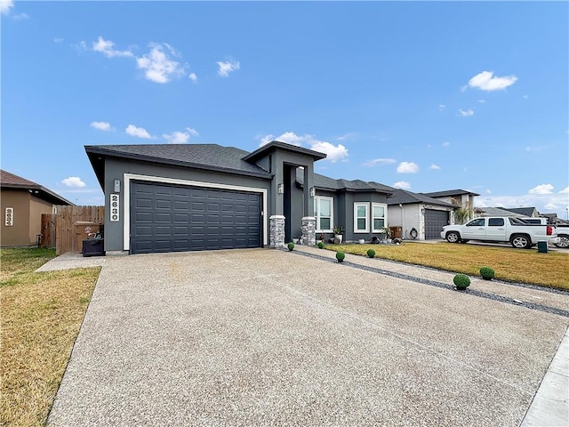 view of front of house featuring a garage and a front lawn