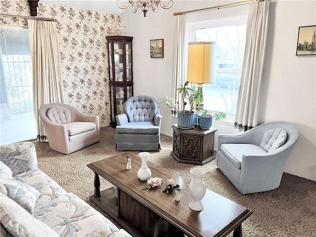 living area featuring a notable chandelier and carpet