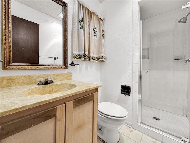 full bathroom with a textured wall, vanity, toilet, tile patterned floors, and a stall shower