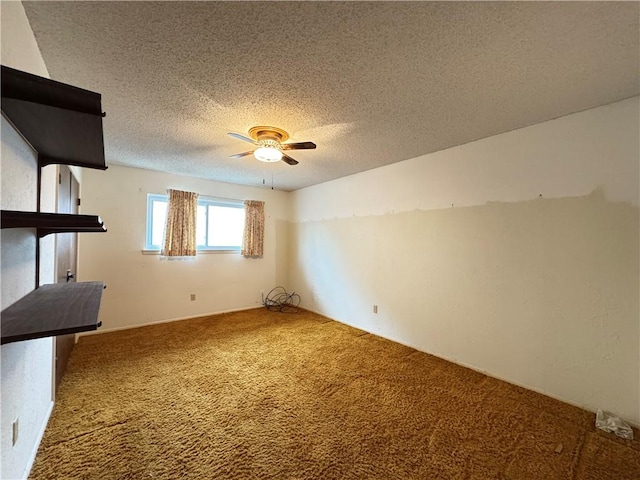 spare room with a ceiling fan, carpet, and a textured ceiling