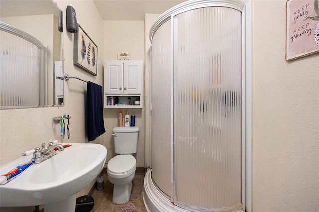 1009 E Sinton St, Sinton, TX 78387 - bathroom featuring a shower stall, a sink, and toilet