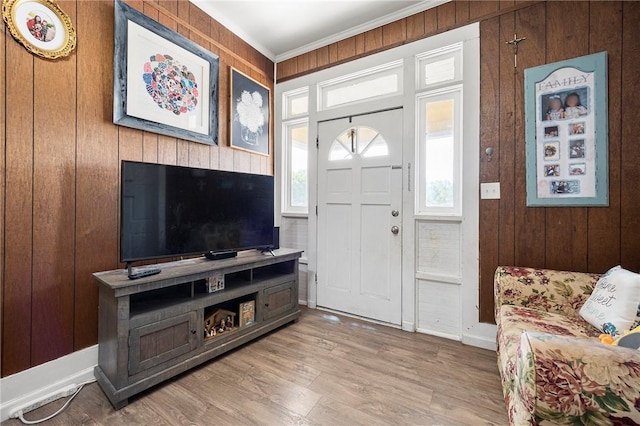 1009 E Sinton St, Sinton, TX 78387 - foyer entrance featuring ornamental molding, plenty of natural light, wooden walls, and wood finished floors