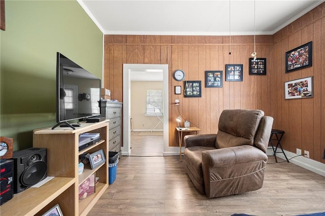 1009 E Sinton St, Sinton, TX 78387 - sitting room with baseboards, ornamental molding, wood finished floors, and wooden walls