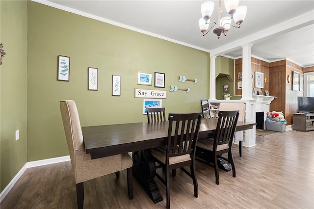 1009 E Sinton St, Sinton, TX 78387 - dining area featuring ornamental molding, wood finished floors, decorative columns, a chandelier, and baseboards