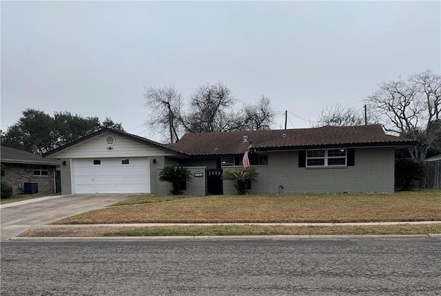 ranch-style home featuring a garage and a front lawn