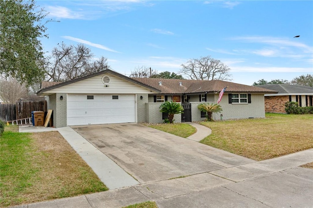 ranch-style home with a garage and a front yard