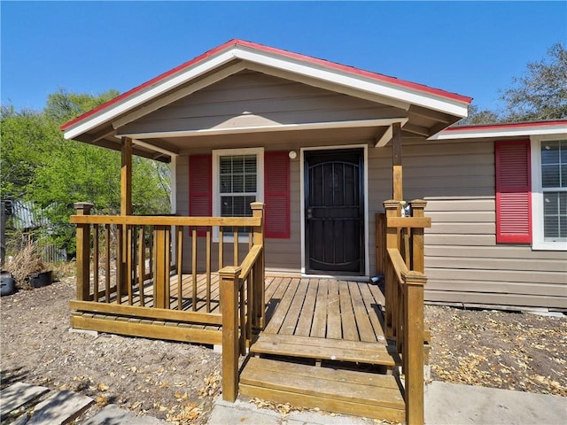 view of exterior entry featuring a deck