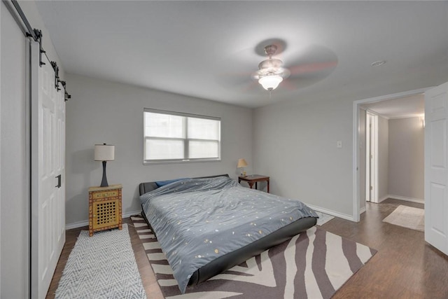 239 Purl Pl, Corpus Christi, TX 78412 - bedroom with a barn door, wood finished floors, and a ceiling fan