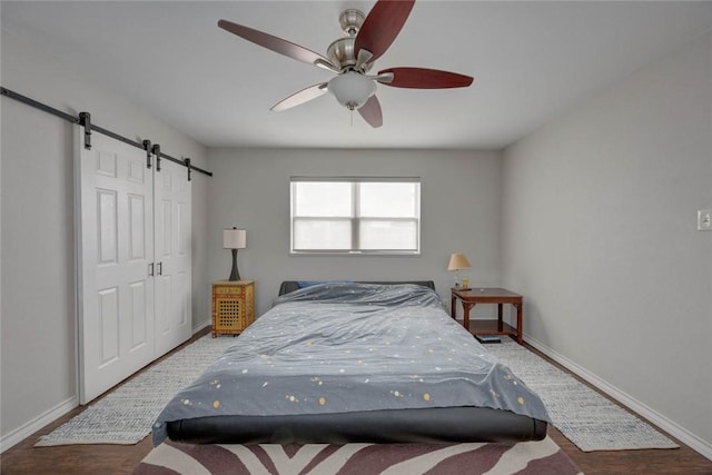 239 Purl Pl, Corpus Christi, TX 78412 - bedroom featuring a barn door, wood finished floors, and ceiling fan
