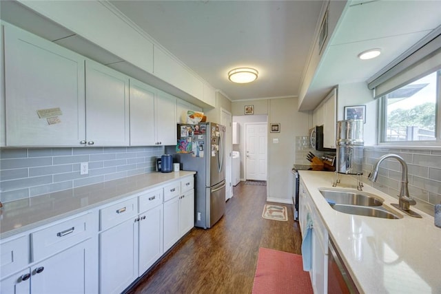239 Purl Pl, Corpus Christi, TX 78412 - kitchen with appliances with stainless steel finishes, ornamental molding, dark wood-type flooring, backsplash, and white cabinets