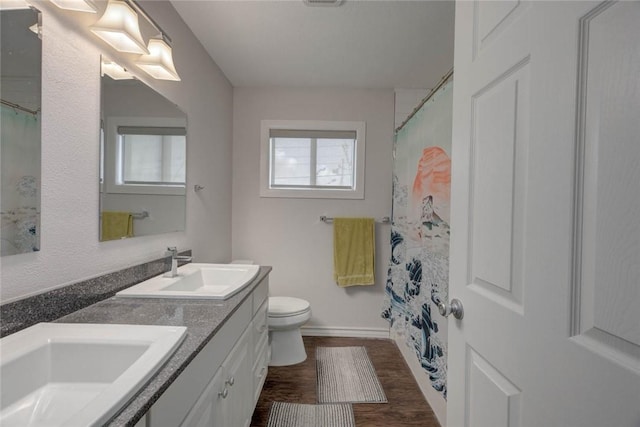 239 Purl Pl, Corpus Christi, TX 78412 - bathroom featuring double vanity, wood finished floors, and a shower with curtain