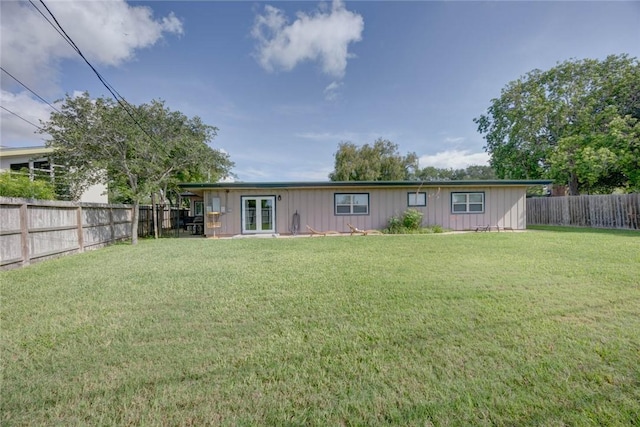 239 Purl Pl, Corpus Christi, TX 78412 - rear view of house with french doors, a fenced backyard, and board and batten siding
