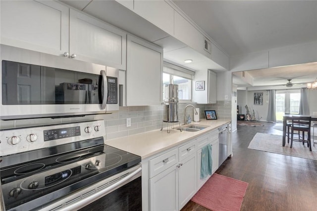 239 Purl Pl, Corpus Christi, TX 78412 - kitchen with appliances with stainless steel finishes, backsplash, dark wood finished floors, white cabinetry, and light countertops