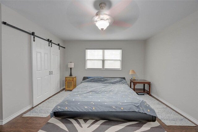 239 Purl Pl, Corpus Christi, TX 78412 - bedroom featuring a barn door, wood finished floors, and ceiling fan
