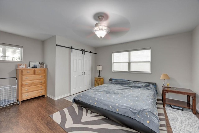 239 Purl Pl, Corpus Christi, TX 78412 - bedroom with a barn door, wood finished floors, a closet, and ceiling fan