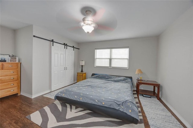 239 Purl Pl, Corpus Christi, TX 78412 - bedroom featuring a barn door, wood finished floors, and ceiling fan