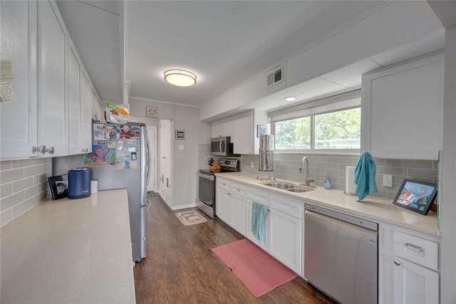 239 Purl Pl, Corpus Christi, TX 78412 - kitchen with stainless steel appliances, backsplash, light countertops, dark wood-style flooring, and white cabinets