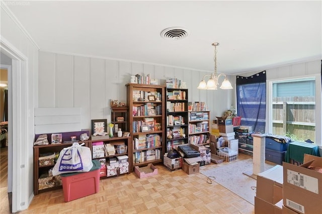 miscellaneous room with a chandelier, light parquet flooring, and crown molding