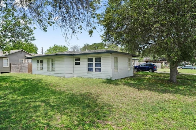 back of house with a lawn