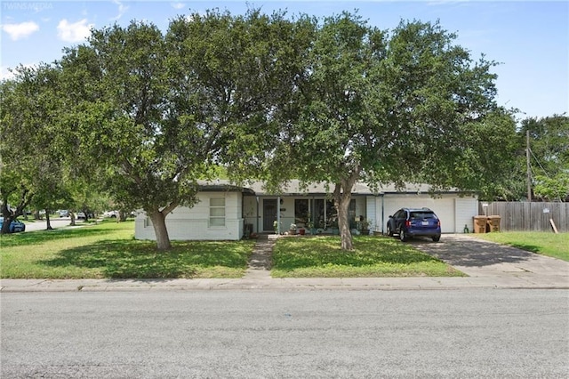 view of front of house featuring a garage and a front yard