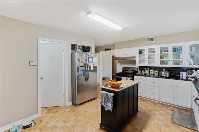 kitchen featuring white cabinetry, appliances with stainless steel finishes, and light parquet floors