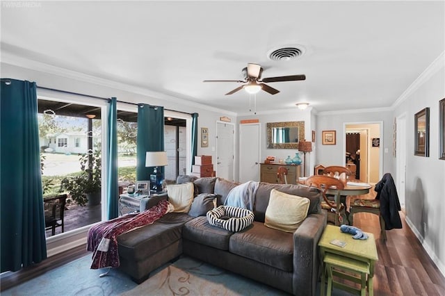 living room with ceiling fan, ornamental molding, and dark wood-type flooring