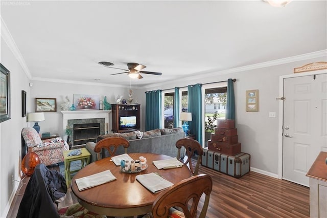 dining room with crown molding, ceiling fan, and dark hardwood / wood-style floors