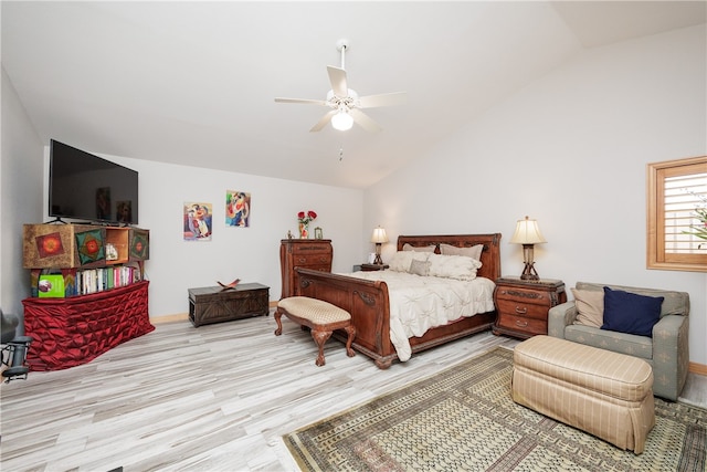 bedroom featuring light hardwood / wood-style floors, ceiling fan, and vaulted ceiling