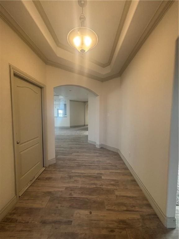 3101 Adak Ct, Corpus Christi, TX 78414 - hallway with arched walkways, a raised ceiling, dark wood-style flooring, ornamental molding, and baseboards