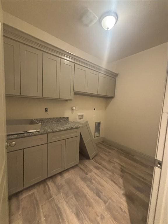 3101 Adak Ct, Corpus Christi, TX 78414 - laundry room with cabinet space, washer hookup, light wood-type flooring, gas dryer hookup, and electric dryer hookup
