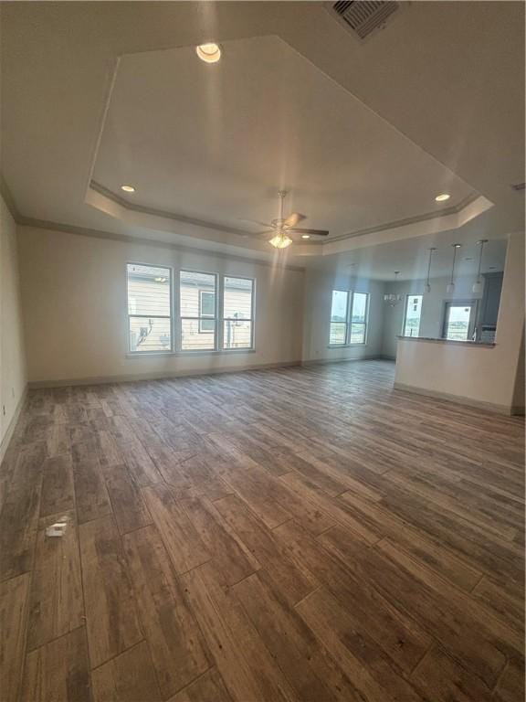 3101 Adak Ct, Corpus Christi, TX 78414 - unfurnished room featuring a tray ceiling, dark wood-style floors, baseboards, a ceiling fan, and recessed lighting