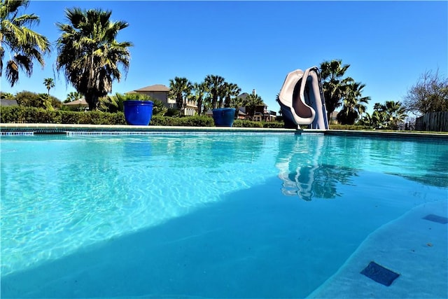 view of swimming pool with a water slide