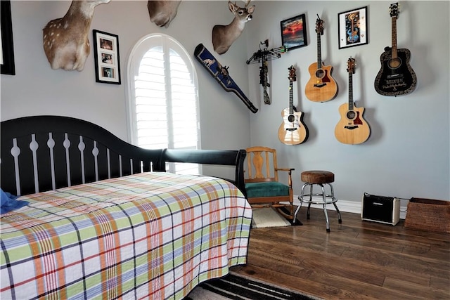 bedroom featuring wood finished floors and baseboards