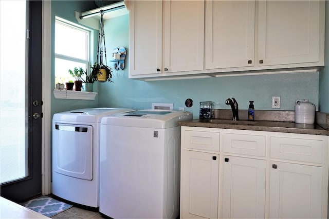 laundry area with a sink, cabinet space, and washing machine and dryer