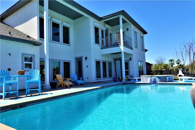 view of swimming pool with a jacuzzi, fence, a fenced in pool, and a patio area