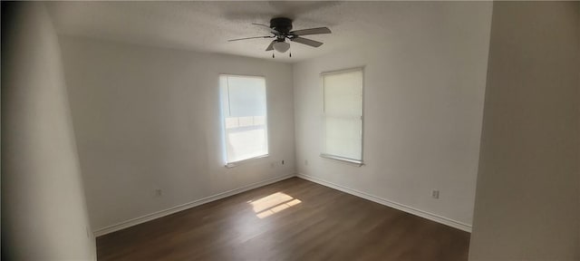 167 Shady Oak, Rockport, TX 78382 - spare room with dark wood-style flooring, a ceiling fan, baseboards, and a textured ceiling