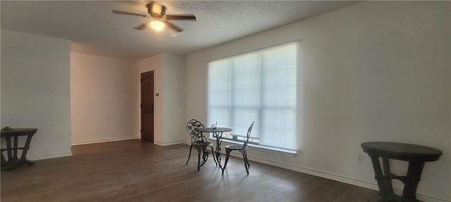 167 Shady Oak, Rockport, TX 78382 - dining area with ceiling fan, dark wood-style flooring, and baseboards