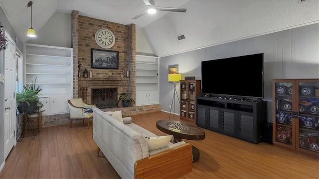 5301 Bromley Dr, Corpus Christi, TX 78413 - living room featuring vaulted ceiling, wood finished floors, built in features, ceiling fan, and a fireplace