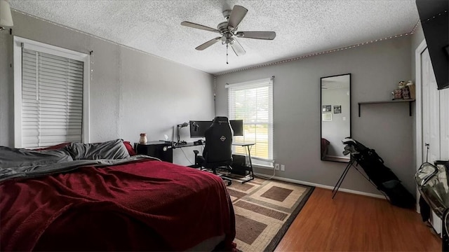 5301 Bromley Dr, Corpus Christi, TX 78413 - bedroom with a textured ceiling, wood finished floors, a desk, and a ceiling fan