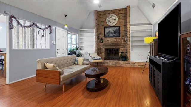 5301 Bromley Dr, Corpus Christi, TX 78413 - living area featuring built in features, wood finished floors, vaulted ceiling, and a fireplace