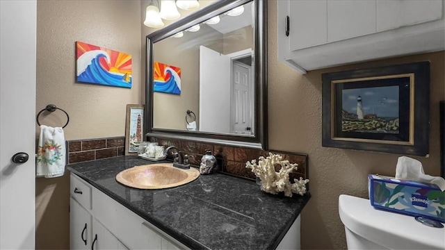 5301 Bromley Dr, Corpus Christi, TX 78413 - half bath with vanity, decorative backsplash, and a textured wall