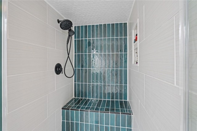 6622 Pharaoh Dr, Corpus Christi, TX 78412 - bathroom featuring tiled shower, tile walls, and a textured ceiling