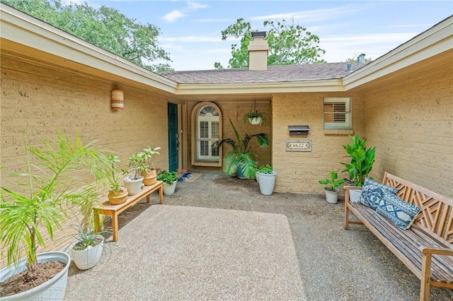 6622 Pharaoh Dr, Corpus Christi, TX 78412 - entrance to property with a patio area, a chimney, brick siding, and roof with shingles