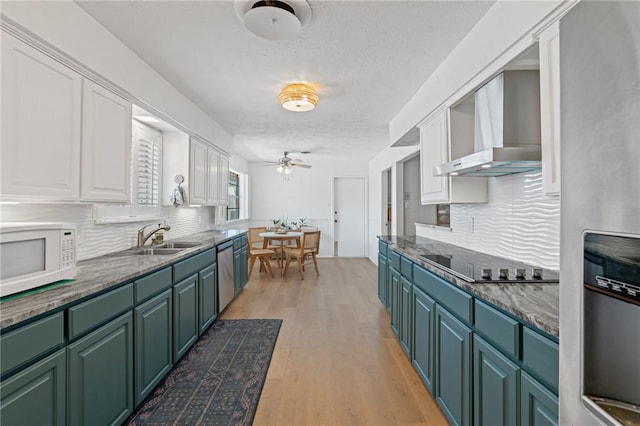 6622 Pharaoh Dr, Corpus Christi, TX 78412 - kitchen with wall chimney range hood, appliances with stainless steel finishes, green cabinets, white cabinetry, and ceiling fan