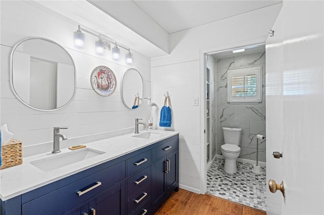6622 Pharaoh Dr, Corpus Christi, TX 78412 - bathroom featuring double vanity, a stall shower, and wood finished floors