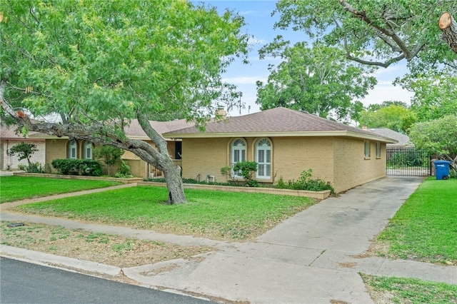 6622 Pharaoh Dr, Corpus Christi, TX 78412 - ranch-style home featuring a front yard, a gate, a chimney, and brick siding