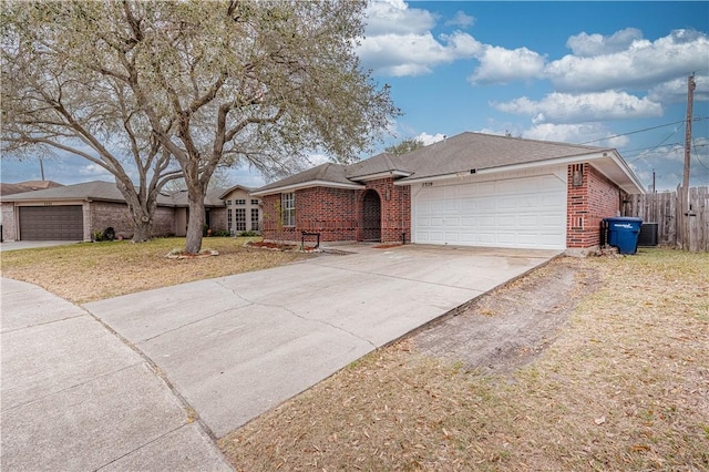 single story home with brick siding, an attached garage, central AC unit, fence, and driveway