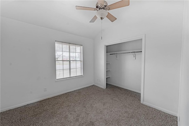 unfurnished bedroom featuring ceiling fan, carpet flooring, baseboards, vaulted ceiling, and a closet