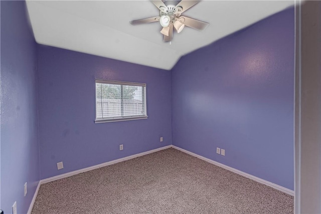 empty room featuring vaulted ceiling, ceiling fan, carpet flooring, and baseboards